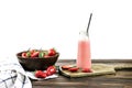 Bottle with strawberry smoothie and strawberries on wooden background. Royalty Free Stock Photo