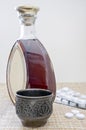 A bottle with a strong drink, a glass, pills Royalty Free Stock Photo