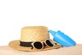 Bottle of sun protection body cream, glasses and straw hat Royalty Free Stock Photo