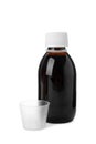 Bottle of syrup with measuring cup on white background. Cough and cold medicine Royalty Free Stock Photo