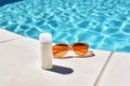 Bottle of tan cream, sunglasses near swimming pool. AI Generative Royalty Free Stock Photo