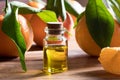 A bottle of tangerine essential oil on a wooden table Royalty Free Stock Photo