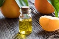 A bottle of tangerine essential oil on a wooden background Royalty Free Stock Photo