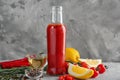 Bottle with tasty tomato sauce, vegetables and condiments on table