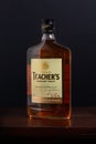Bottle of Teacher`s Highland Cream Scotch whiskey on a dark background