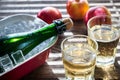 Bottle and two glasses of cider on the wooden background Royalty Free Stock Photo