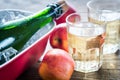 Bottle and two glasses of cider on the wooden background Royalty Free Stock Photo