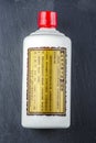 Bottle of typical strong chinese liquer isolated on stone slate stone background.