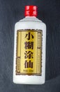 Bottle of typical strong chinese liquer isolated on stone slate stone background.