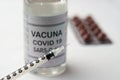 Covid-19 vaccine and a syringe