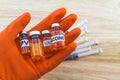 Bottle vaccine of Human papillomavirus HPV vaccine in red glove