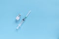 Bottle with vaccine and medicine syringe with vaccine on blue background. Concept of vaccination and healthcare Royalty Free Stock Photo