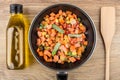 Bottle of vegetable oil, frying pan with vegetable mix Royalty Free Stock Photo