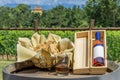 A bottle of vin santo with its wooden box and a tray of cantuccini resting on top of a wooden barrel in Tuscany, Italy Royalty Free Stock Photo