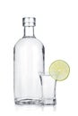 Bottle of vodka and shot glass with lime slice Royalty Free Stock Photo