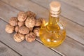 A bottle of walnut oil and a pile of walnuts