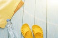 Bottle of water and bright towels, yellow shale on blue background. Royalty Free Stock Photo