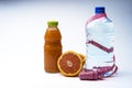 Bottle of water with centimeter and grapefruit juice from fresh grapefruit on grey background Royalty Free Stock Photo