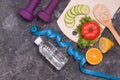 bottle of water, dumbbells, measuring tape, diet food on a black background Royalty Free Stock Photo