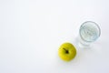 Bottle of water, green apple, glass of water and measuring tape isolated on white.