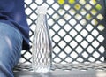 Bottle of water placed on a steel chair beside a man wearing trousers blue jeans in the garden. Royalty Free Stock Photo