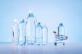 Bottle Of Water In Shopping Trolley And Group Of Plastic Bottles Royalty Free Stock Photo