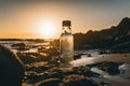 A bottle of water sitting on top of a rocky beach. AI generative image.
