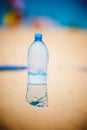 Bottle of water standing in sand at the beach Royalty Free Stock Photo