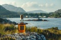 A bottle of whiskey is adjacent to a beautiful mountainous area with a pond