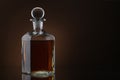 Bottle of whiskey on brown background