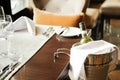 A bottle of white wine in ice bucket on the background of a served table in a restaurant Royalty Free Stock Photo