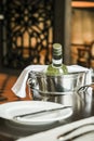 Bottle of white wine in an ice bucket served in a restaurant Royalty Free Stock Photo