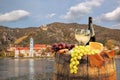 Bottle of wine on barrel with Durnstein village in Wachau, Austria