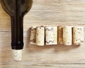 A bottle of wine closed with a stopper on the wooden background. Corks and bottleneck close up Royalty Free Stock Photo