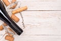 Bottle of wine, corkscrew and corks on wooden table. Background Royalty Free Stock Photo