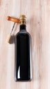 Bottle of wine and corkscrew over wooden background Royalty Free Stock Photo