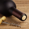 Bottle of Wine and Corkscrew on Wood