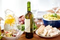 Bottle of wine and food on served wooden table