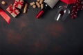 Bottle of wine, gift box, red grapes, corkscrew and corks, on ru