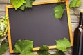 Bottle of wine with a glass and grapes on a wooden table with copy space, top view. Concept on the topic of wine business Royalty Free Stock Photo