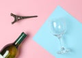 Bottle of wine, glass, statuette of Eiffel Tower on a colored pastel background. Top view. Minimalism