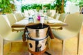 Bottle of wine opened in a bucket to cool it, in a Mediterranean restaurant with vineyards