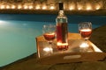 Bottle of wine at poolside Royalty Free Stock Photo