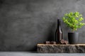 A bottle of wine and a potted plant on a table next to a pile of chocolates Royalty Free Stock Photo