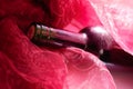 Bottle of wine in red drapery