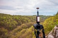 A bottle of wine stands on a tripod above spring beech forest in a nature reserve in southern Sweden