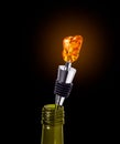 Bottle of Wine with a Stopper from Amber isolated on black background Royalty Free Stock Photo