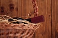 Bottle of wine with straw in basket