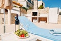 A bottle of wine, two glasses and fruit on the beach near the sunbed. In the shade of an umbrella, in the villa. Royalty Free Stock Photo