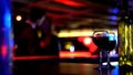 Bottle of wine with two glasses, kissing young couple on blurred background